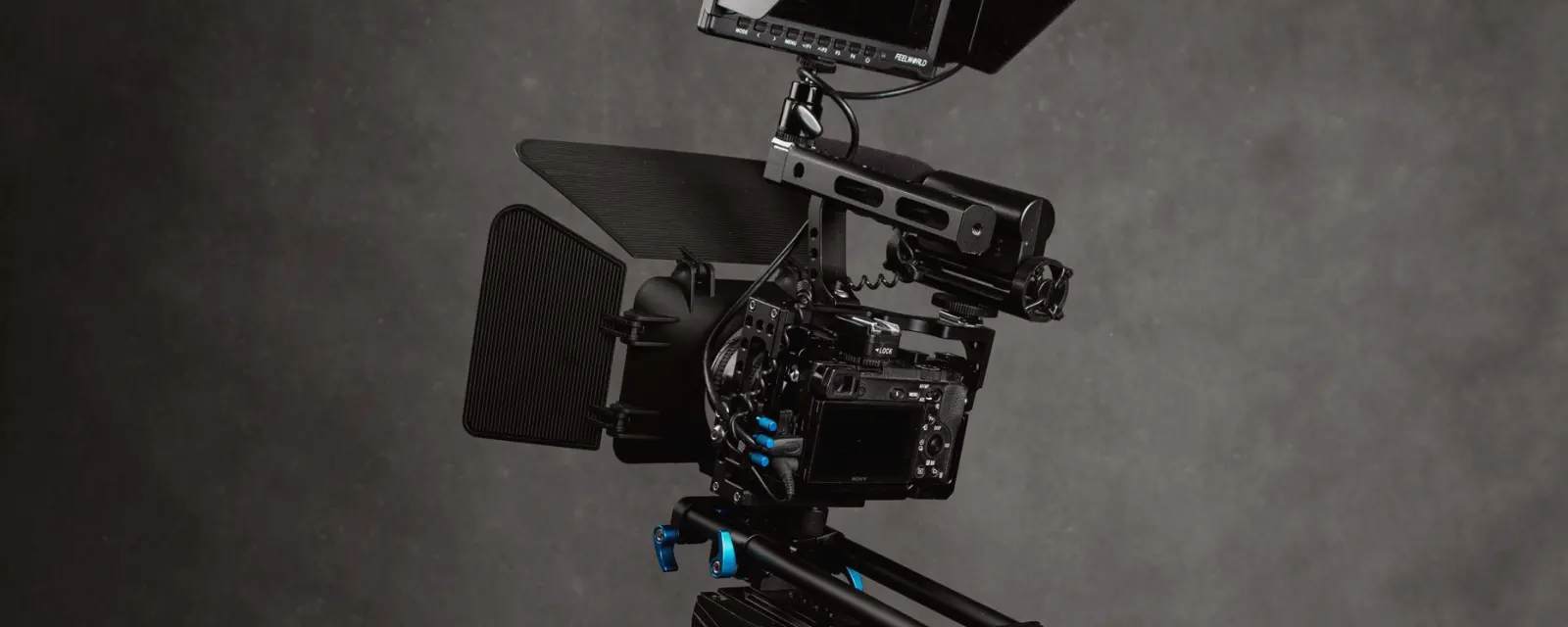 A small studio with camera, tripod and monitor set up for an interview framing exercise
